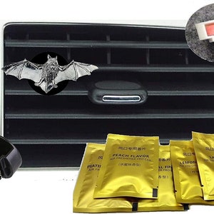 May include: A set of six gold car air fresheners with different scents: Peach, Lemon, Lavender, and two others in Chinese characters. The air fresheners are packaged in individual foil pouches. A black plastic car vent clip is included. A silver bat-shaped car vent clip is also included.
