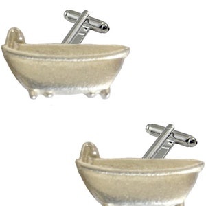 May include: A pair of silver cufflinks shaped like a bathtub. The cufflinks are a fun and unique accessory for any occasion.