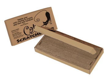 May include: A cardboard box with a cat scratching post inside. The box is brown and has black text that reads "Satisfy your cat's craving to scratch and save your furniture! 100% Made in America. Double-sided. All Natural. Safe for the Earth. Safe for your pet. Cat Scratcher."