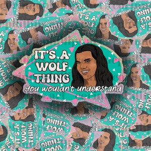 May include: A teal green and pink sticker with a cartoon illustration of a person with long dark hair and the text "It's a wolf thing you wouldn't understand."