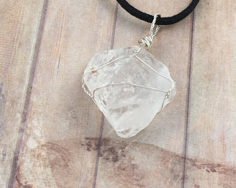 Raw quartz crystal wrapped in sterling silver wire, complete with black neck cord