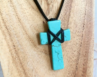 Turquoise dyed Howlite cross with macrame wrap and bail, complete with black neck cord