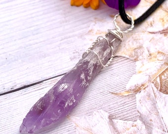 Long rough amethyst point wrapped in sterling silver wire. Black neck cord or sterling silver chain