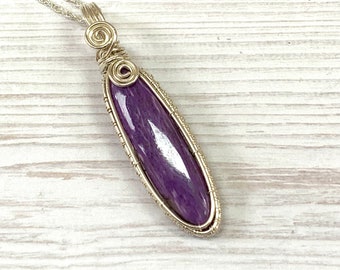 Charoite wrapped in sterling silver, with black neck cord or sterling silver chain