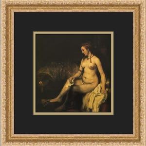 May include: A framed painting of a nude woman seated on a bed, holding a cloth. The artwork features a dark background with warm tones, and is set within a gold ornate frame.