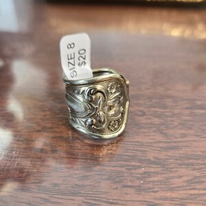 May include: Silver spoon ring with an ornate floral design. The ring is size 8 and costs $20.