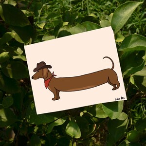 May include: A cartoon illustration of a brown dachshund wearing a brown cowboy hat and a red bandana. The dachshund is standing on a light pink background.