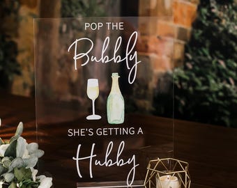 Pop The Bubbly She's Getting A Hubby Clear Glass Look Acrylic Wedding Sign, Cocktail Bar Bubbly Champagne Drinks Bridal Shower Sign