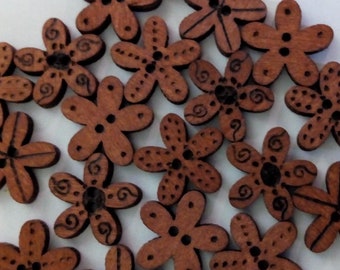 May include: A collection of 20 brown wooden flower-shaped buttons with intricate designs. 