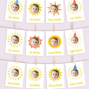 May include: Twelve yellow sun-shaped cards with a baby's photo in each. Each card has a different month of the year written on it, from one to twelve months.