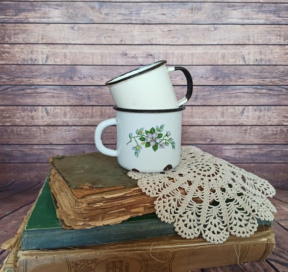 Rustic enamel coffee cup with word coffee on it and decorative