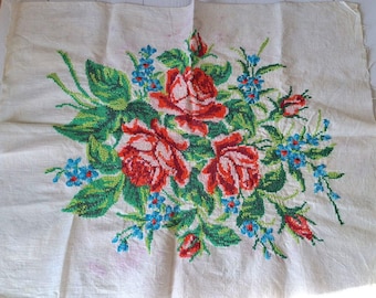 May include: White fabric with an embroidered design of a bouquet of red, pink, and white roses with green leaves and blue flowers.