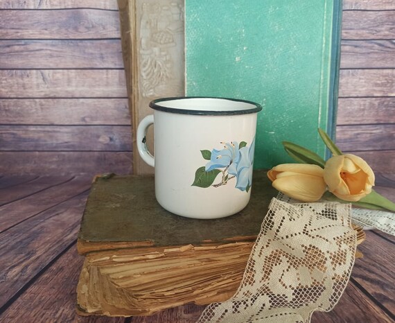 Rustic enamel coffee cup with word coffee on it and decorative