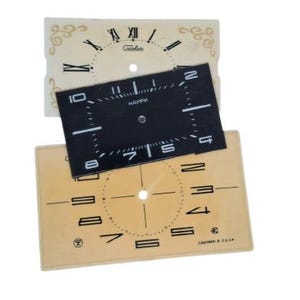 May include: Three vintage watch faces in cream and black. The top face is cream with Roman numerals and decorative flourishes. The middle face is black with white numerals and the word "HAPM". The bottom face is cream with black numerals.