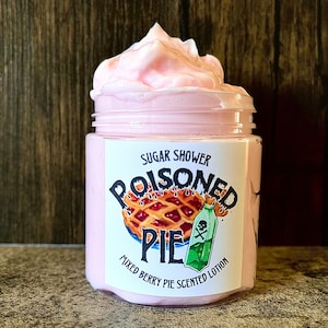 May include: A pink jar of Sugar Shower Poisoned Pie Mixed Berry Pie Scented Lotion. The jar has a white label with a cartoon image of a pie and a bottle with a skull and crossbones.