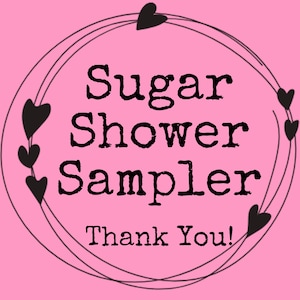 May include: A pink background with the words "Sugar Shower Sampler" in black, surrounded by a black heart-shaped design. The words "Thank You!" are at the bottom.