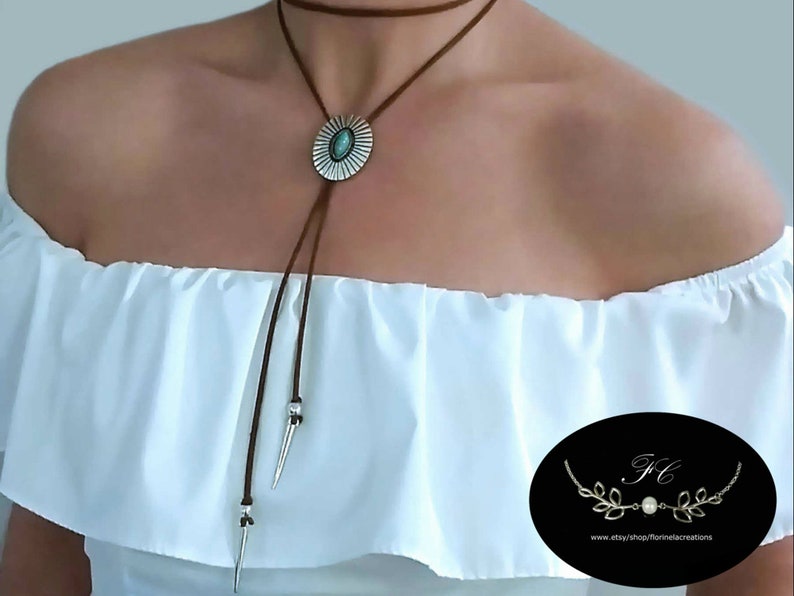 Modern western bolo tie necklace for women boho, ancient silver metal oval shape flower Concho with a marquise shape turquoise gemstone decoration slide over a 48 inch length cognac leather lace, silver spikes décor both ends of the leather lace.