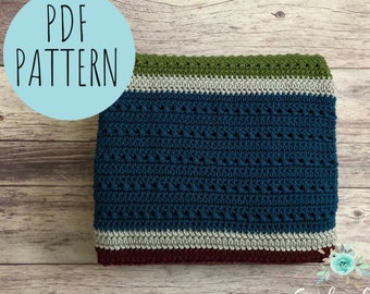 May include: A PDF pattern for a crocheted blanket with stripes of teal, gray, green, and burgundy. The blanket is folded and lying on a wooden surface. The text "PDF PATTERN" is in a blue circle.