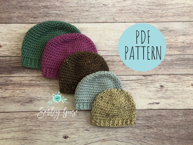 May include: Five crocheted hats in different colors, including green, purple, brown, blue, and beige, arranged in a row on a wooden surface. The text "PDF PATTERN" is visible in a blue circle.