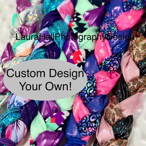 May include: A close-up of a braided fabric headband with a variety of colorful patterns, including pink, purple, blue, green, and black. The headband is made of multiple strips of fabric that are woven together to create a unique and stylish design. The text "Custom Design Your Own!" is visible in the center of the image.