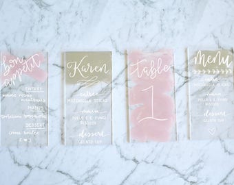 Brush stroke painted back clear acrylic signs | wedding event | place card, menu, table numbers | pink, silver, white