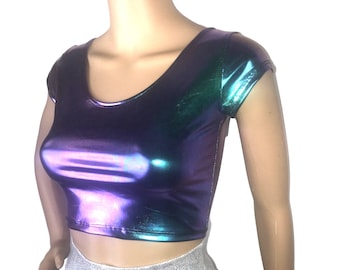 May include: A metallic iridescent crop top with short sleeves. The top is a gradient of purple, blue, and green.