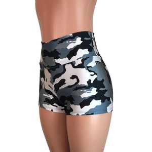 May include: High-waisted shorts with a camouflage print in shades of gray, black, and white. The shorts are made of a shiny, stretchy fabric.