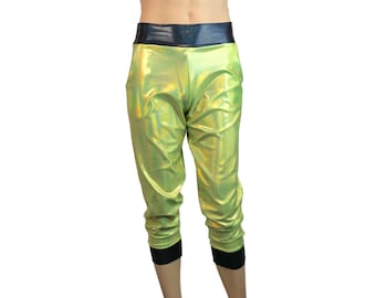 May include: Green metallic cropped pants with a black waistband and black cuffs. The pants have a slight sheen and are made of a stretchy material.