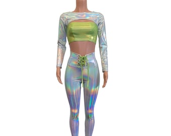 May include: A silver holographic crop top with long sleeves and a green lace-up detail. The top is paired with silver holographic leggings with a green lace-up detail at the waist.