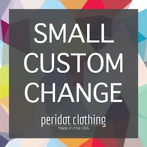 May include: A black and white graphic with the text "SMALL CUSTOM CHANGE" and the words "peridot clothing" in a smaller font below. The text "Made in the USA" is in an even smaller font below the company name.