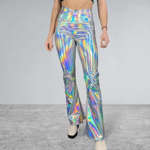 May include: Silver iridescent flared pants with a high waist and a criss-cross design at the front.