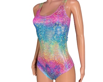 May include: A sleeveless bodysuit with a rainbow iridescent pattern. The fabric has a textured, glittery finish.