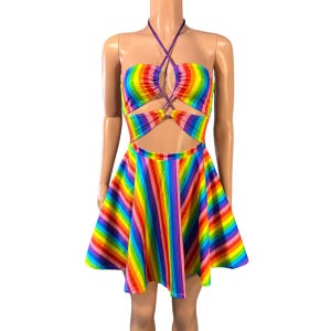 May include: A rainbow striped mini dress with a halter neckline and a cut-out design at the midriff. The dress has a fitted bodice and a flared skirt.