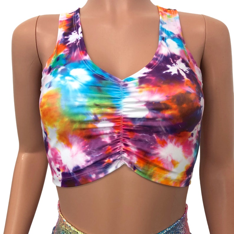 May include: A tie-dye crop top with a rainbow color scheme. The top has a scoop neck and a gathered front.