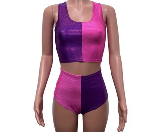 May include: A two-piece outfit with a cropped tank top and high-waisted shorts. The top and shorts are split down the middle, with one side purple and the other side pink. The fabric has a sparkly finish.