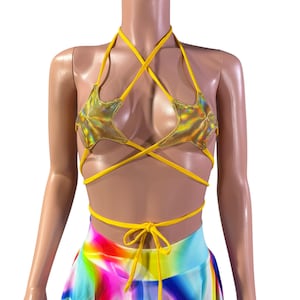 May include: Yellow halter top with gold star accents. The top is made of a stretchy fabric and has adjustable straps. The top is tied at the back and can be worn as a crop top or a bikini top.