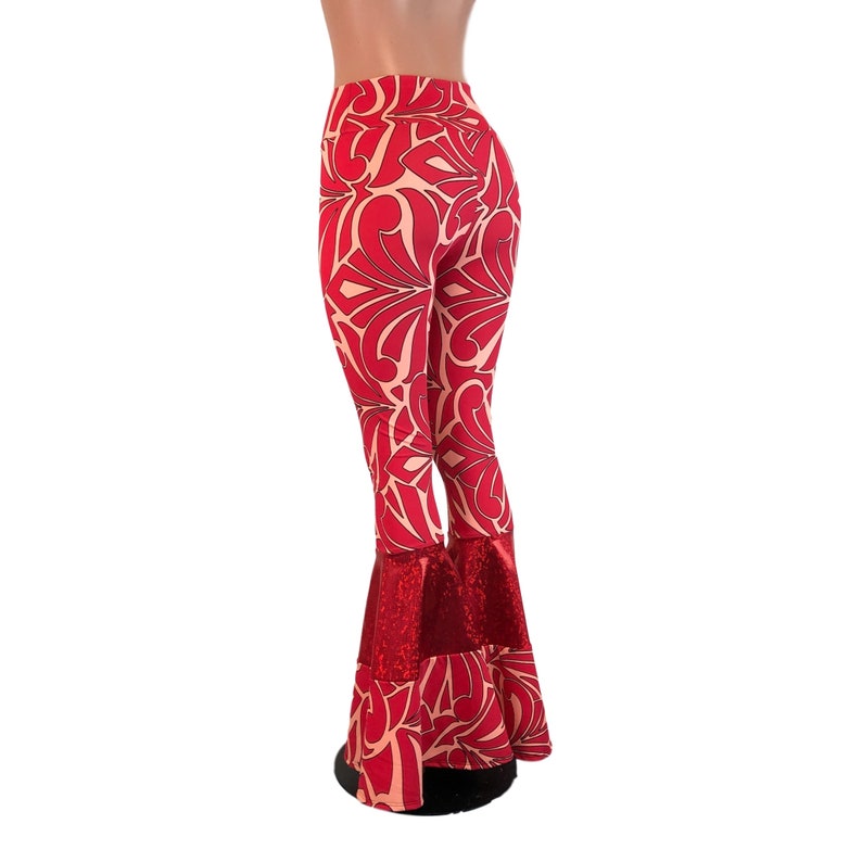 May include: Red and cream bell-bottom trousers with a geometric pattern. The trousers have a red sequined trim at the bottom.
