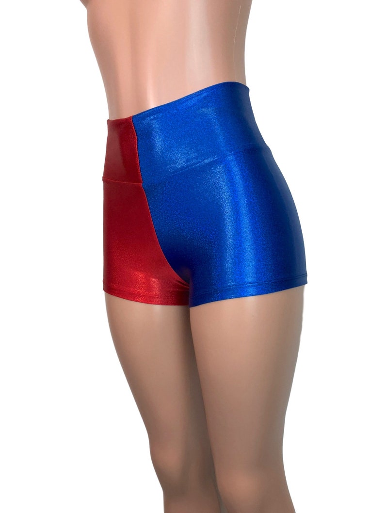 May include: High-waisted shorts with a red and blue color block design. The shorts are made of a shiny, stretchy fabric.