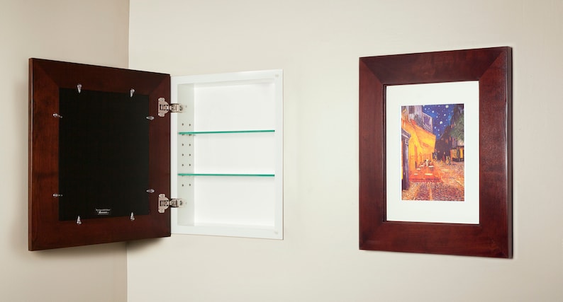 May include: A mahogany framed mirror with a hidden medicine cabinet behind it. The cabinet has two glass shelves. A framed picture with a painting of a street scene hangs on the wall to the right.