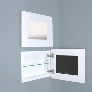 May include: White recessed medicine cabinet with a mirror and an open door revealing a glass shelf. The cabinet is mounted on a light blue wall. The mirror is framed in a white square.