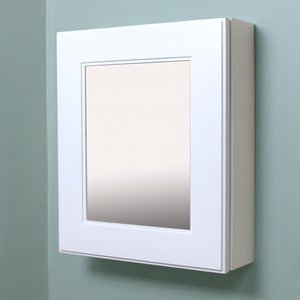 May include: A white framed medicine cabinet with a mirrored door. The cabinet is mounted on a light green wall.