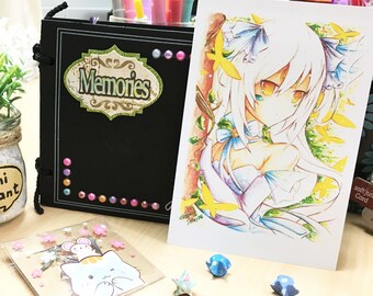 May include: A black scrapbook with the word "Memories" on the cover, a white card with a drawing of a white-haired anime character with yellow eyes, a small clear container with a green plant and a label that says "Mini Plant", and a small clear plastic bag with a cartoon cat and mouse design.