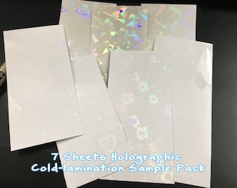 May include: Seven sheets of holographic cold-lamination sample pack. The sheets are white with iridescent patterns.