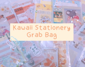May include: A clear plastic bag filled with various kawaii stationery items, including stickers, washi tape, and notepads. The bag is labeled "Kawaii Stationery Grab Bag".