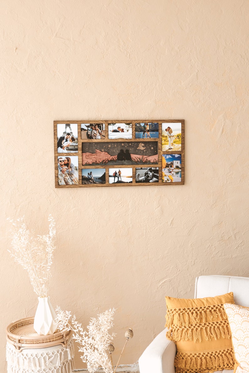 May include: A rectangular wooden collage photo frame featuring a central horizontal panel with a laser-cut silhouette of a couple sitting under a moon and stars, surrounded by eight individual photo slots displaying various outdoor couple portraits.