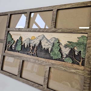 Può includere: Una cornice per foto in legno con una scena di montagna e il testo "Se sai quanto vale la vita, cercherai la pace sulla terra". La cornice ha otto aperture per foto.