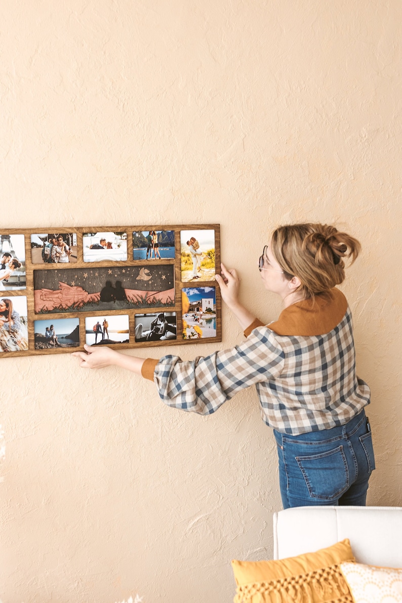 May include: A rectangular wooden multi-photo frame featuring a central horizontal panel with a laser-cut silhouette of two people sitting on a hill under a crescent moon and stars, surrounded by ten individual photo slots in various orientations.