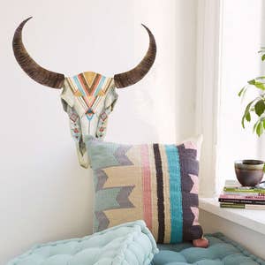 May include: A teal blue floor cushion with a geometric patterned pillow on top. The cushion is in a living room setting with a wall decal of a stylized bull skull with geometric patterns in shades of brown, orange, pink, and blue. The text "100% removable by StickersColoray Etsy Shop" is visible in the bottom right corner of the image.