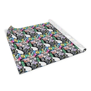 May include: A black and white wrapping paper with a repeating pattern of colorful cassette tapes and boomboxes. The design is reminiscent of 80s and 90s music.