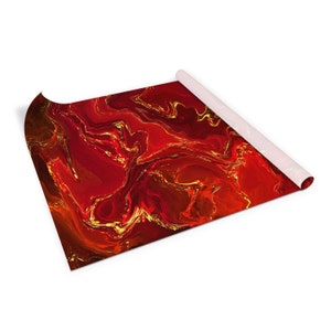 May include: A red and gold abstract marbled design wrapping paper. The paper is rolled up and the end is visible.